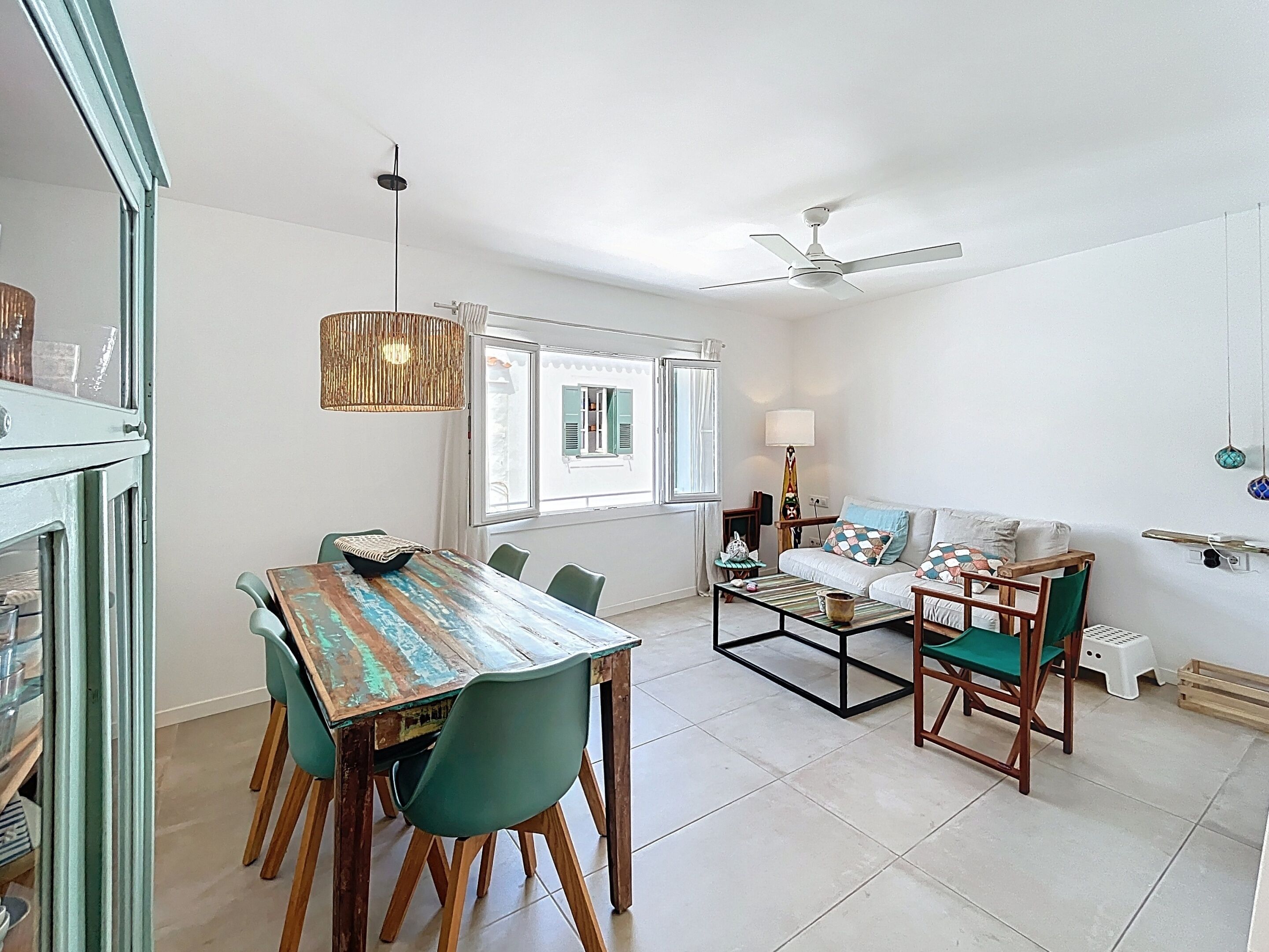Spacious, bright dining room with air conditioning and ceiling fan.