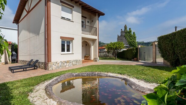 A two-story house with a stone foundation, a balcony, and a small pond in the backyard. - Casa Margarita in Rada (Rada)
