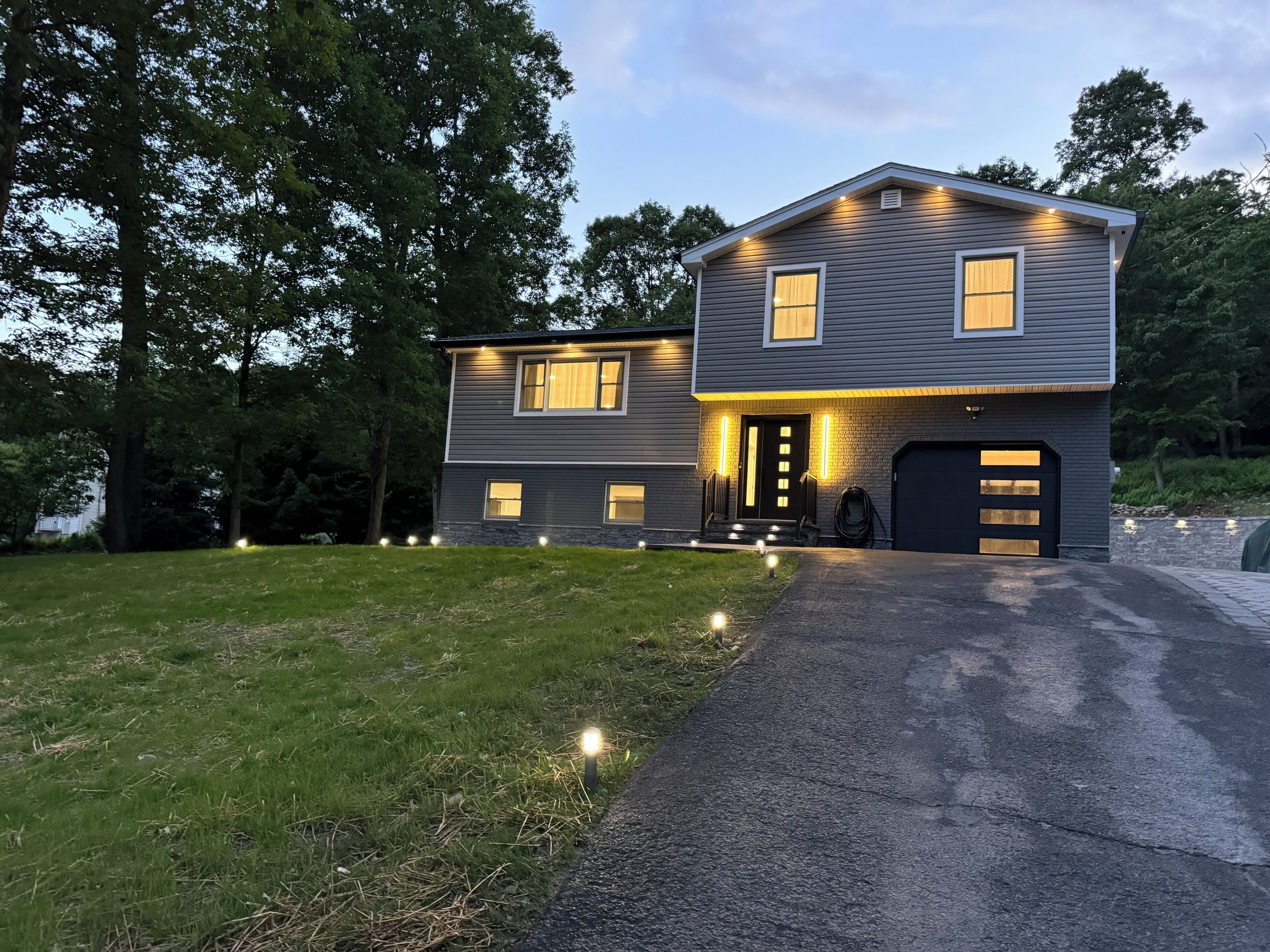 A two-story house with a garage, a front porch, and a driveway.