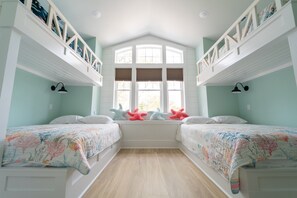 A room with two beds, a window with shutters, and a white ceiling. - Happy Tides Hideaway/NEW!/Pool/Kids Adventure Room (Oak Island)