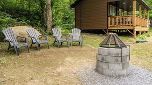 A cabin with a deck, two Adirondack chairs, and a fire pit. - Nature & Wildlife Escape | Alfred Shack (Frampton)