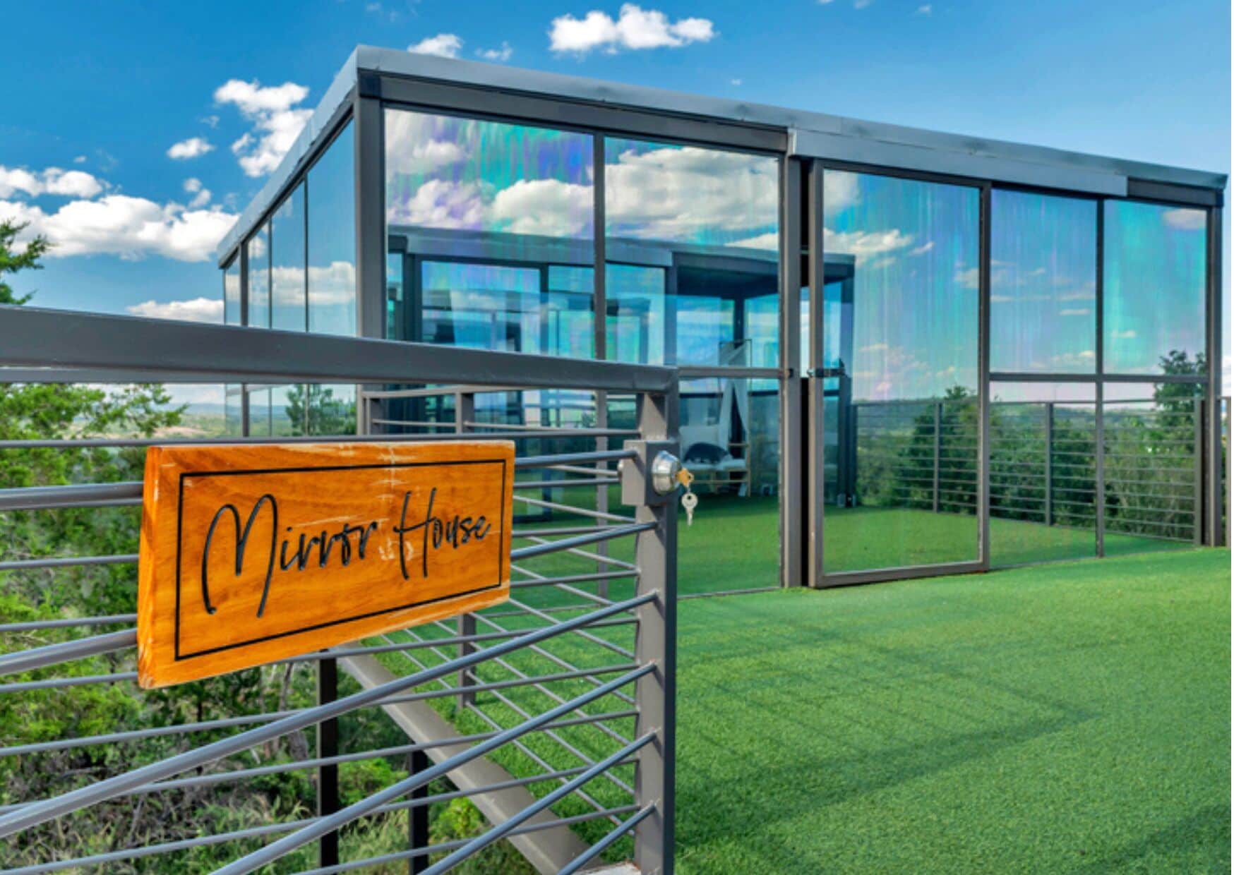 A modern glass building with a sign reading 'Minner House' in front.