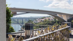 A bridge with a view of a river and a town below. - E: Sweeping Panoramic Terrace | Douro Views (Vila Nova de Gaia)