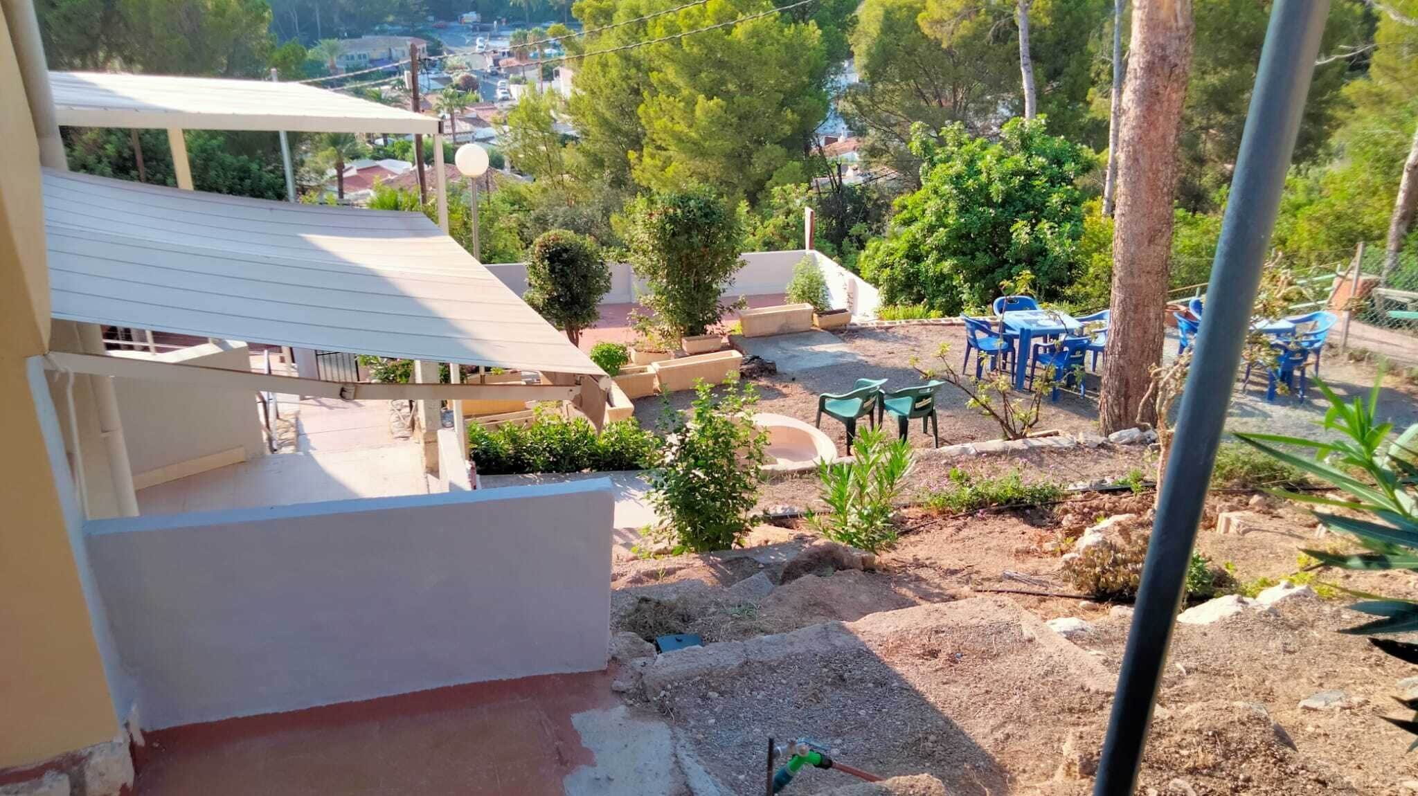 A residential area with a patio, outdoor seating, and a view of the neighborhood.