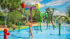 A water park with various water play structures, including a water slide, a splash pad, and a water fountain. - Bahama Bay Spacious 3BR Condo + Resort Amenities (Davenport)