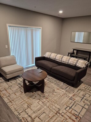 A living room with a sofa, a chair, a coffee table, and a fireplace. - Keefer Creek A106 (Dogs Welcome!) (Fort Wayne)