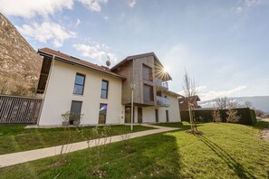 A modern two-story house with a balcony, a pathway, and a view of the mountains. - Le Petit Élégance – Au pied du Taillefer (Duingt)
