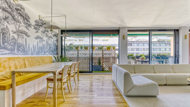 A modern living room with a wooden dining table, chairs, a sofa, and a balcony with potted plants. - L'Atelier de Sèvres - 2 places de parking (Boulogne-Billancourt)