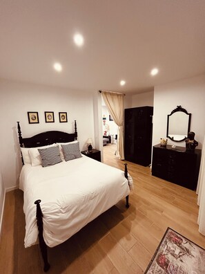 A bedroom with a bed, dresser, mirror, and framed pictures on the wall. - CASA DOCE - Rustic house in Corotelo (São Brás de Alportel)