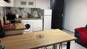 A compact kitchen with a washing machine, a sink, and a microwave. - Aurore des îles-F3- 2bedroom with jacuzzi and terrace (Le François)
