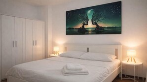 A bedroom with a bed, two bedside lamps, a wardrobe, and a wall-mounted painting. - Vibes Pigneto, central location near metro C stop suitable for families (Roma)