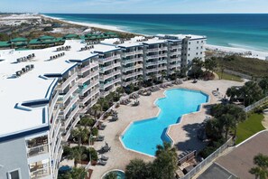 A hotel with multiple balconies, a swimming pool, and a beach view. - Destin West V402👙Gulf Front🏖️Free Beach Setup (Fort Walton Beach)