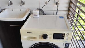 A Samsung digital inverter washing machine with a 10-year warranty, located in a room with a tiled floor, a sink, and a window with blinds. - Providencia 2BR 2BA Apt + Private Parking (Providencia)