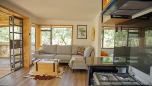 A cozy living room with a sofa, a coffee table, and a fireplace.