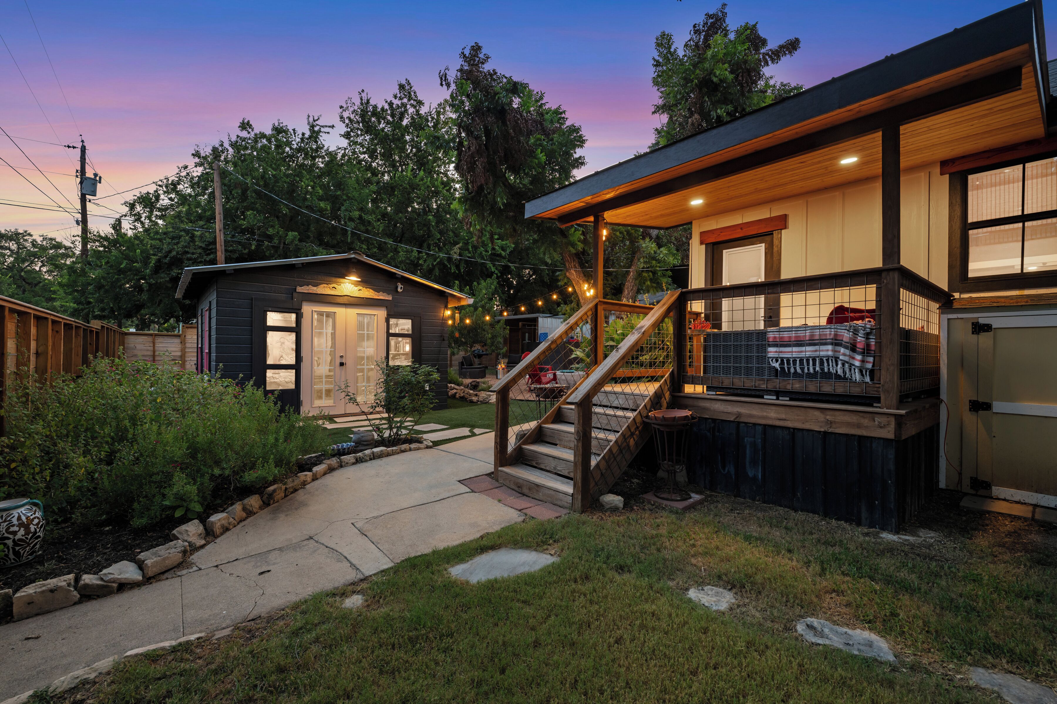 A two-story house with a covered porch and a small attached garage.