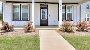 A house with a front porch, a black front door, and a number '2616' on the wall. - Masters/ANWA Rental Retreat (Grovetown)