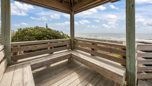 A wooden deck with a view of the ocean and beach. - Island Beach and Racquet Club B104: Oceanfront Condo with Views, Community Amenities (Atlantic Beach)