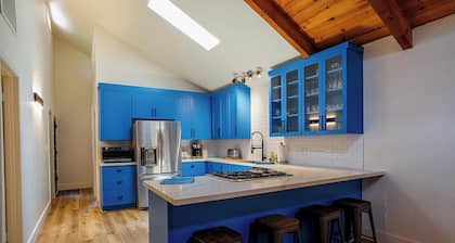 Renovated 4-bedroom cabin with 2 primary suites, 2 living areas and a huge deck.