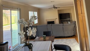 A living room with a sofa, a coffee table, and a TV.