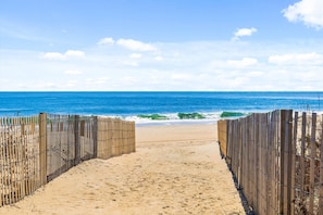 A beach path leading to the ocean with a wooden fence on either side. - Oceanfront 2BR Condo | Steps to Beach | Sleeps 8 (Ocean City)