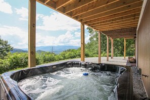 A hot tub under a wooden pergola with a view of mountains and greenery. - Hummingbird Heights, Smoky Mt Views! Sleeps 10! (Bryson City)