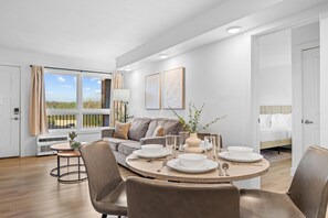 A modern living room with a dining area, a sofa, and a bed. - Relaxing Lake Taneycomo Condo Steps from Downtown Branson (Branson)