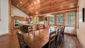 A spacious kitchen with wooden cabinets, a central island, and large windows. - Monthly Lease - Freedom Lodge by Tahoe Getaways - 4BR Centrally Located w/ Bonus Room (Truckee)