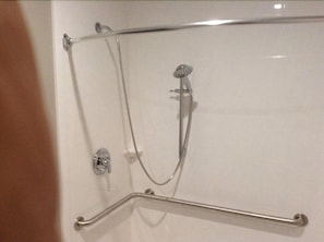 A shower with a handheld showerhead and a handheld shower bar. - Guesthouse Inn Houston Cypress (Cypress)