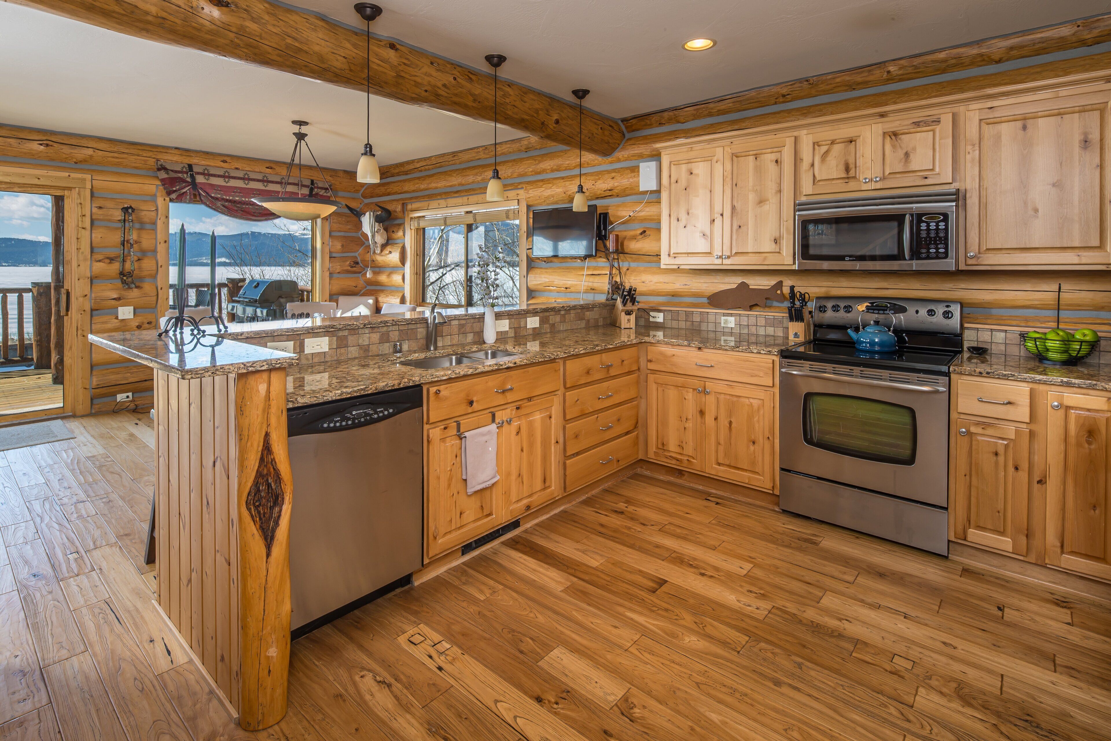 A kitchen with wooden cabinets, a stainless steel stove, and a dishwasher.