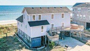 A beachfront house with a balcony, a small deck, and a view of the ocean. - York - Duck, Carolina Dunes, Oceanfront, Ocean View, Hot Tub, Large Decks, Pets OK (Duck)