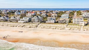 A coastal residential area with beachfront properties, sandy beach, and ocean waves. - York - Duck, Carolina Dunes, Oceanfront, Ocean View, Hot Tub, Large Decks, Pets OK (Duck)