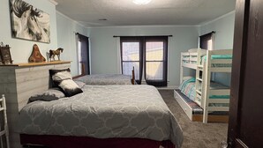 A bedroom with two beds, a dresser, a window with curtains, and a bunk bed. - Traditional Bed & Breakfast in Irvine KY with Swimming pool, Wi-Fi Room 2 (Irvine)