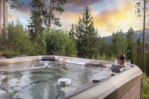 A hot tub surrounded by trees with a bottle and glass on it. - Unmatched Elegance, Pool Table, Hot Tub, Ski Shuttle, Fire PIt with Views!! (Breckenridge)