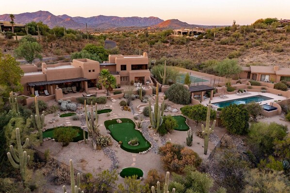 A desert resort with multiple buildings, a pool, and a golf course. - NEW 6BR Carefree Estate with Views | Tennis, Pickleball, Pool, Infinity Spa, Golf & Views (Carefree)
