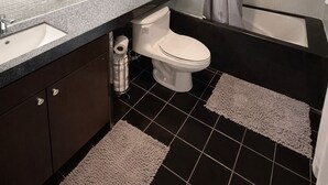 A bathroom with a toilet, sink, and shower. - Modern Loft 1BD/1BA in King West (Toronto)