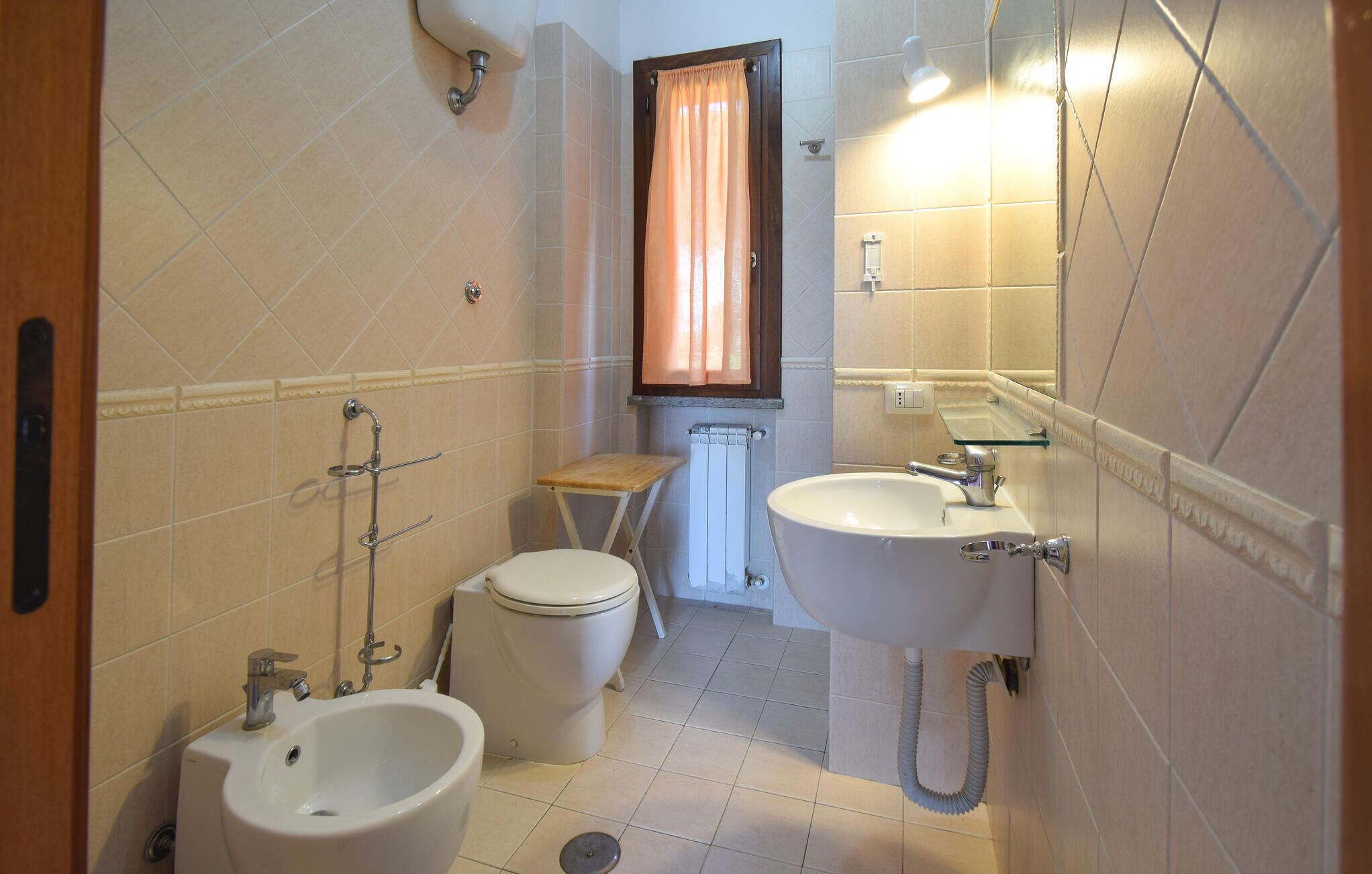 Ein Badezimmer mit Toilette, Bidet, Waschbecken und Dusche.