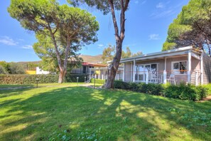 A two-story house with a covered porch and a well-maintained lawn. - Sea View - 40 Parallelo - Deluxe 25, Marina di Camerota, Italy (Marina di Camerota)