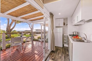 A modern kitchen with a view of a deck and a balcony. - Sea View - 40 Parallelo - Superior 13, Marina di Camerota, Italy (Marina di Camerota)