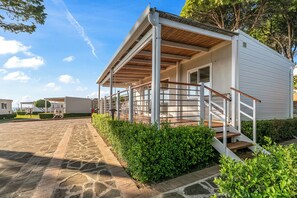 A white building with a covered porch and a staircase leading to the entrance. - Sea View - 40 Parallelo - Superior 13, Marina di Camerota, Italy (Marina di Camerota)