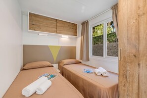 A room with two single beds, a window with curtains, and a wooden headboard. - Sea View - 40 Parallelo - Superior 11, Marina di Camerota, Italy (Marina di Camerota)