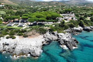 A coastal resort with modern villas, rocky cliffs, and clear turquoise waters. - Sea View - 40 Parallelo - Deluxe 6, Marina di Camerota, Italy (Marina di Camerota)