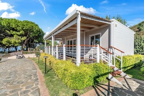 A small, single-story building with a covered porch and a staircase leading to the entrance.