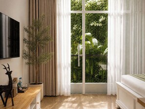 A room with a large window, a potted plant, a wooden table, and a flat-screen TV. - Amana Boutique Hotel - Tran Quoc Thao (Xuan Hoa)