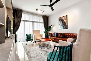 A modern living room with a sofa, armchair, and coffee table.