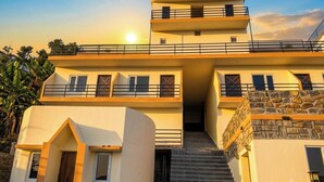 A multi-story building with a central staircase leading to an upper level. - Malabar Cottage - Panoramic Mountain View (Kodaikanal)