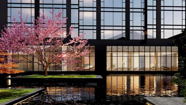 Un edificio moderno con amplios ventanales, un estanque de carpas y un cerezo en flor.