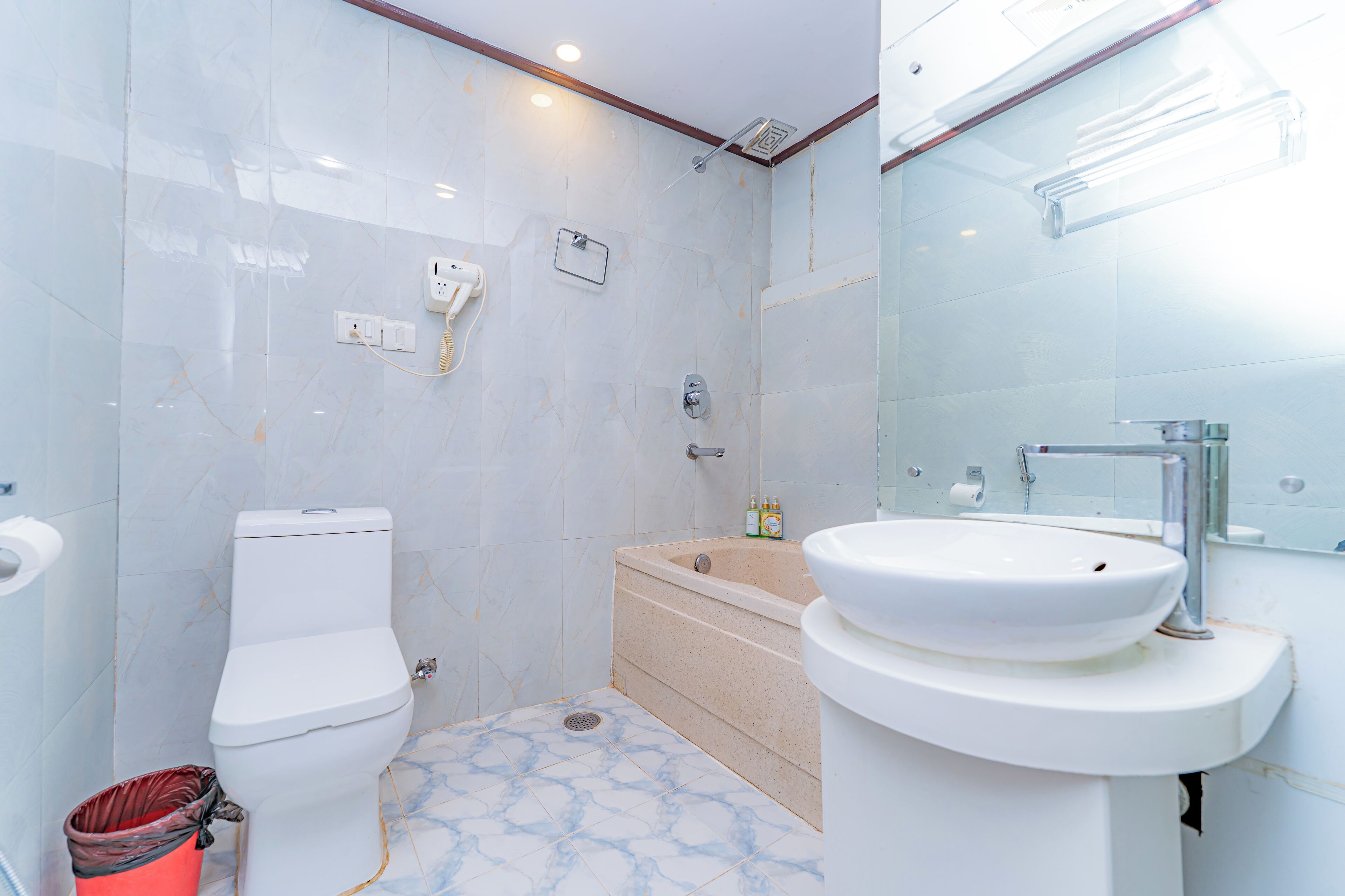 A bathroom with a toilet, bathtub, and sink.