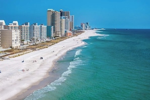 A coastal cityscape with a beach, high-rise buildings, and a clear sky. - Beachfront Gulf Shores Condo, Views, Pool, Private beach access, Walk to Dining  (Gulf Shores)
