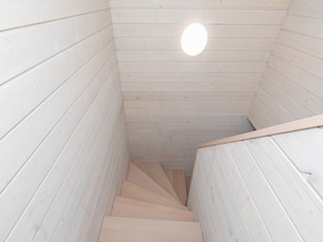 A wooden staircase with a circular light fixture at the top. - Cottage in Pobierowo Near Baltic Beach (Rewal)
