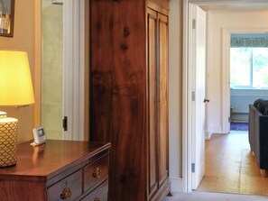 A wooden dresser with drawers, a lamp, and a thermostat on a table. - 3 bedroom accommodation in Near Bath (Bradford-on-Avon)